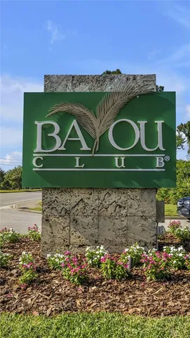 a kitchen with granite countertop a sink a stove top oven and cabinetry