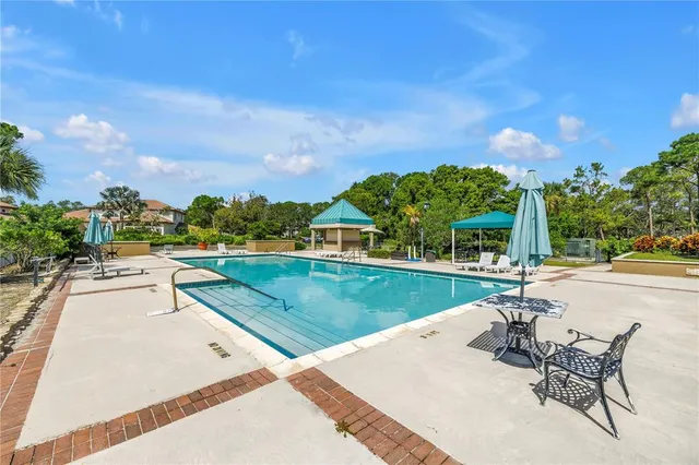 a kitchen with stainless steel appliances granite countertop a refrigerator a stove a sink and a refrigerator