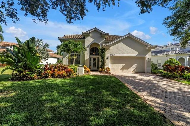 a view of a house with pool and sitting area