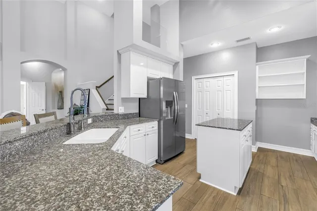 a view of a yard with plants and trees