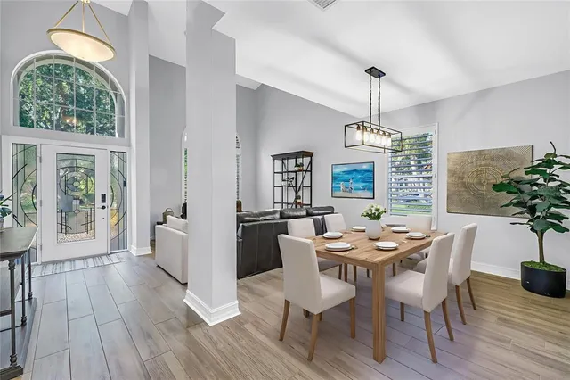a view of a dining room with furniture window and wooden floor