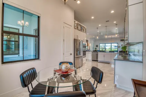 a dining room with furniture and a chandelier