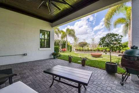 a view of a patio with table and chairs potted plants with wooden floor