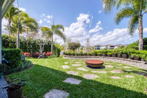 a view of a backyard with plants and a fountain
