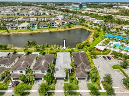 an aerial view of residential houses with outdoor space and lake view