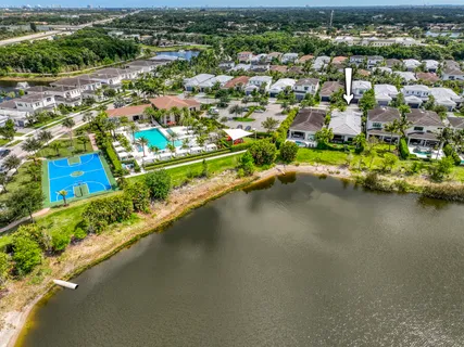an aerial view of residential houses with outdoor space and lake view