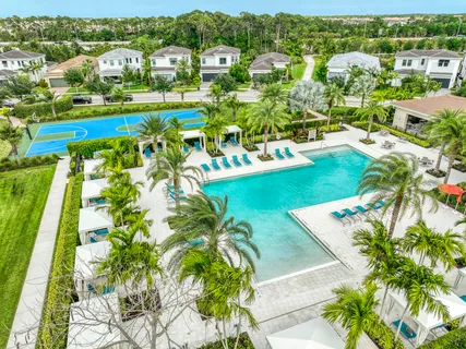 an aerial view of residential houses with outdoor space and street view