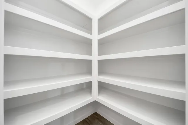 a view of walk in closet with empty racks