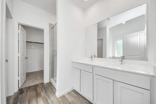 a bathroom with a double vanity sink and mirror