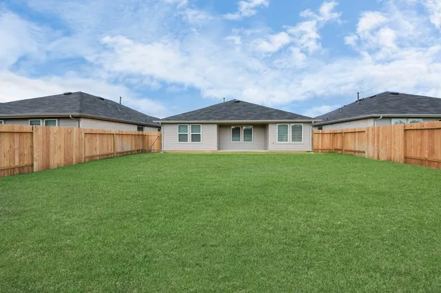 a view of a backyard with grass and stairs
