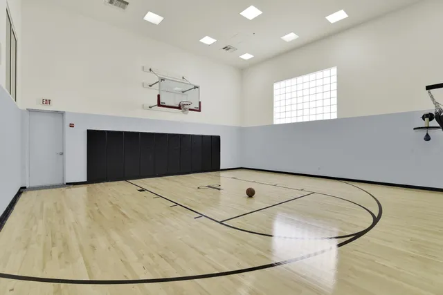a view of a room with a ceiling fan and wooden floor