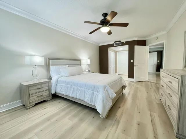 a spacious bedroom with a bed and a chandelier
