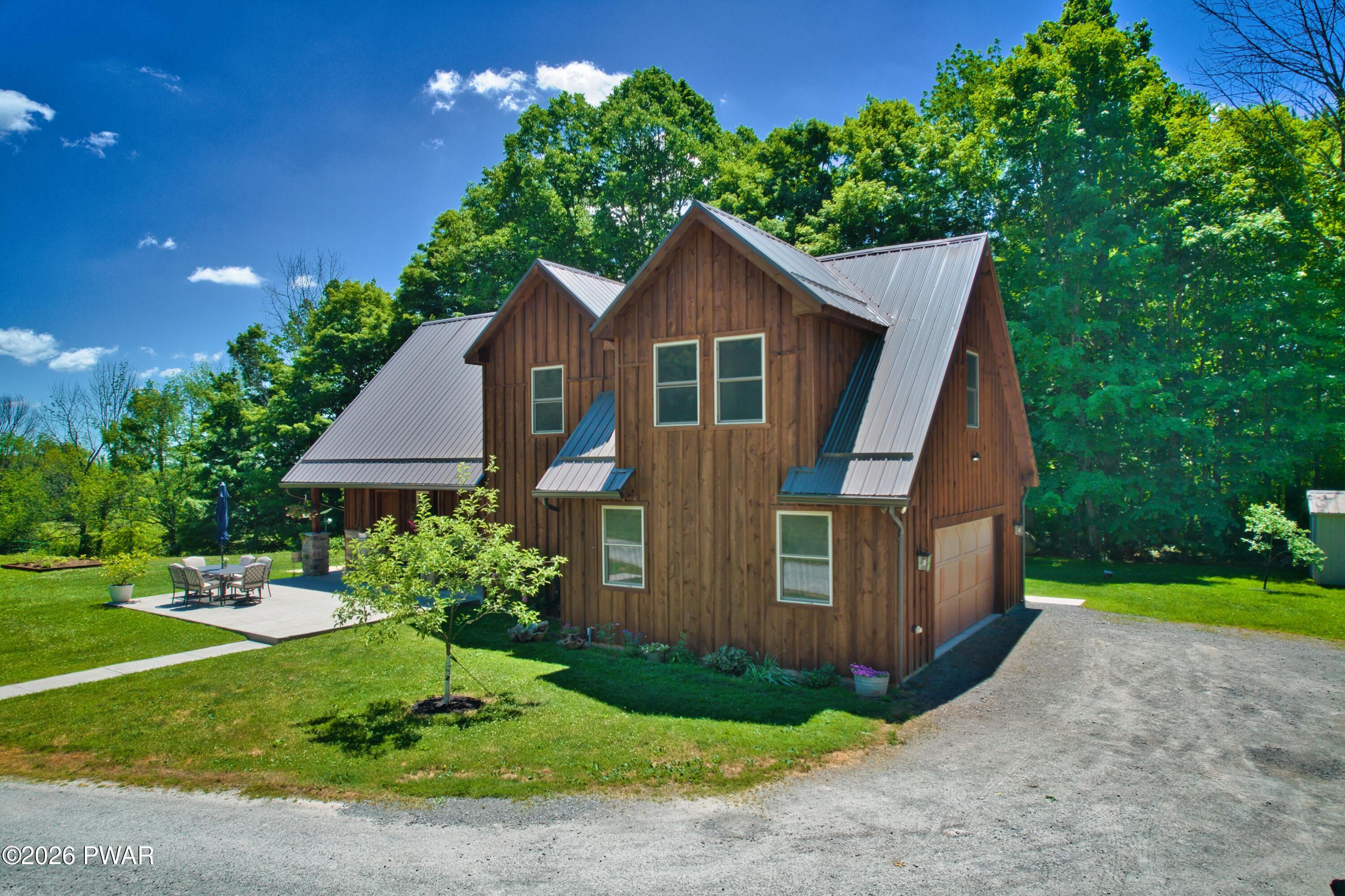 149 Sheards Road Milanville, PA 18443 - Photo 5 of 57 a front view of a house with garden