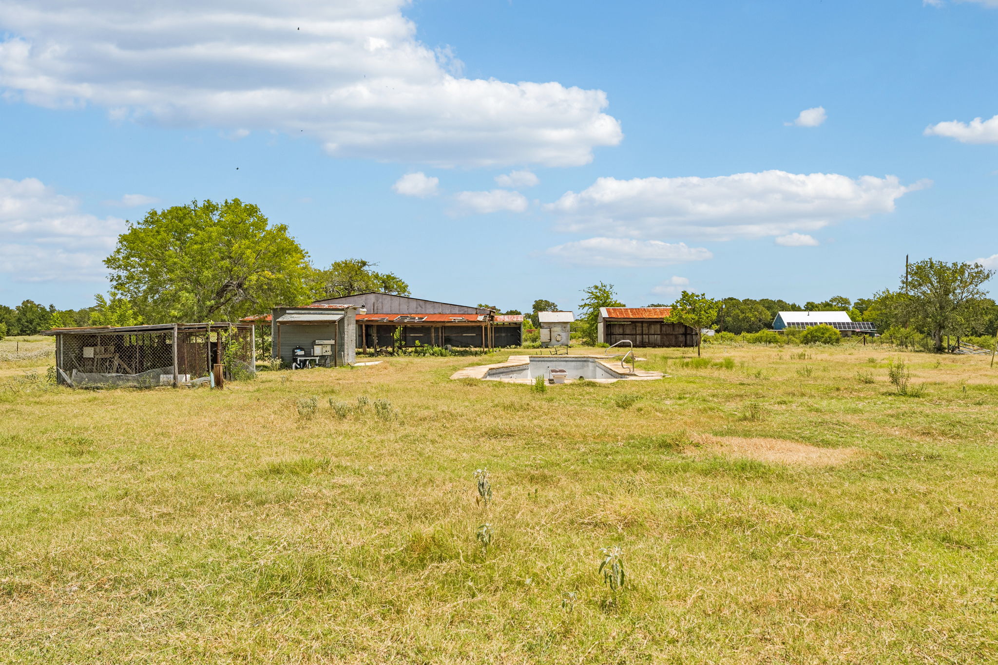 9765 A State Park Road Lockhart, TX 78644 - Photo 17 of 30 Unleash your rural aspirations on this vast expanse, featuring multiple outbuildings and an in-ground pool.