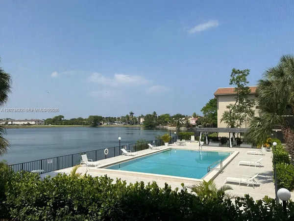 an aerial view of a house with outdoor space and lake view in back
