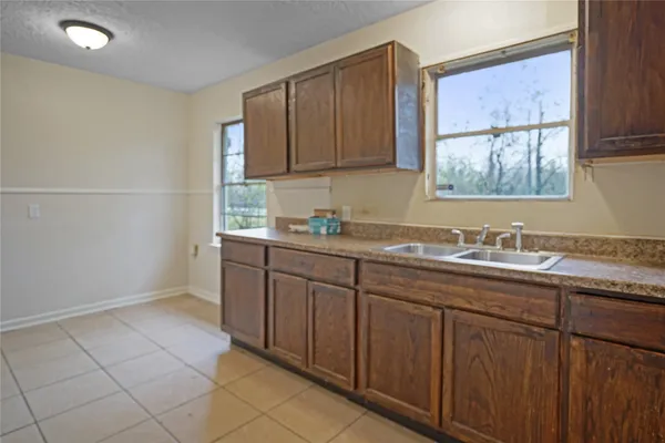 a bathroom with a granite countertop sink and a window