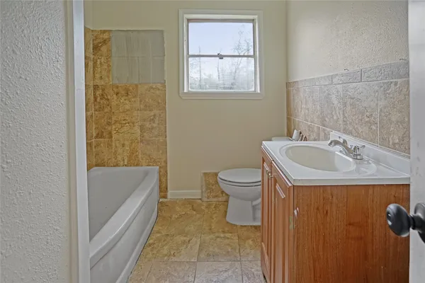 a bathroom with a sink a toilet and bathtub
