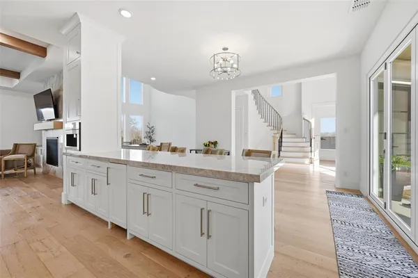 a spacious bathroom with a double vanity sink a mirror a bathtub and windows