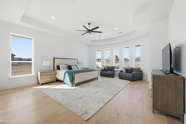 a bedroom with furniture and a flat screen tv