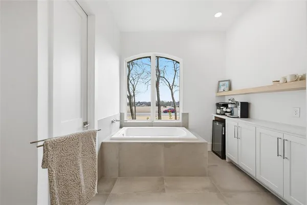 a large white kitchen with cabinets