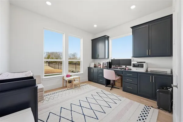 a living room with furniture a flat screen tv and large window