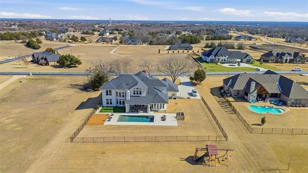 an aerial view of a house with a swimming pool