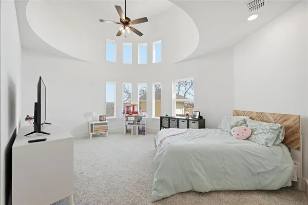 a bedroom with bed and a chandelier