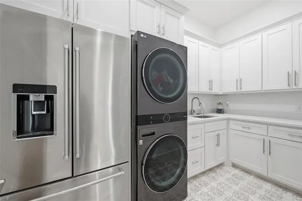 a utility room with sink dryer and washer