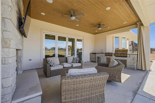 a living room with couches and kitchen view