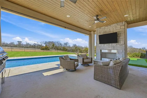 a living room with fireplace furniture and a flat screen tv