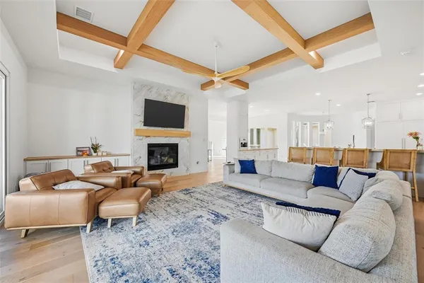 a living room with furniture a flat screen tv and a fireplace