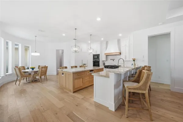 a living room with furniture a dining table and kitchen view