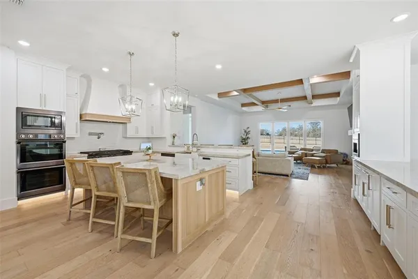 a kitchen with stainless steel appliances kitchen island granite countertop a large island in the center