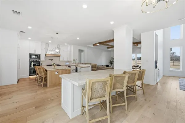 a kitchen with kitchen island wooden cabinets and stainless steel appliances