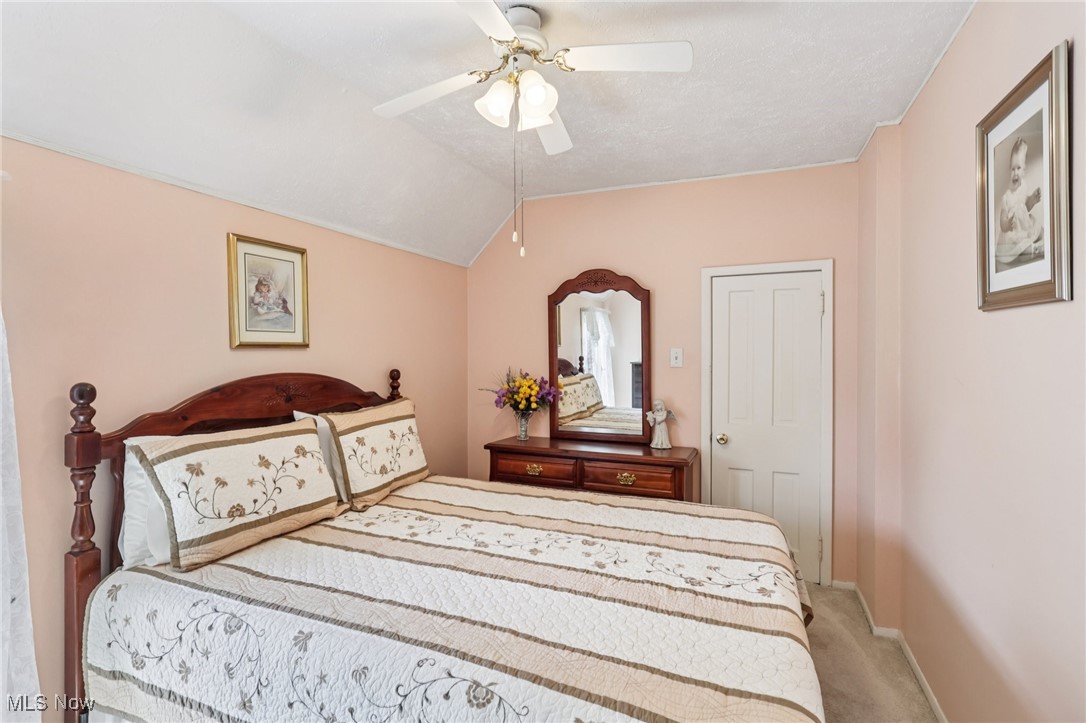 10818 Dixon Road Cleveland, OH 44111 - Photo 31 of 44 Bedroom with light colored carpet, vaulted ceiling, and ceiling fan