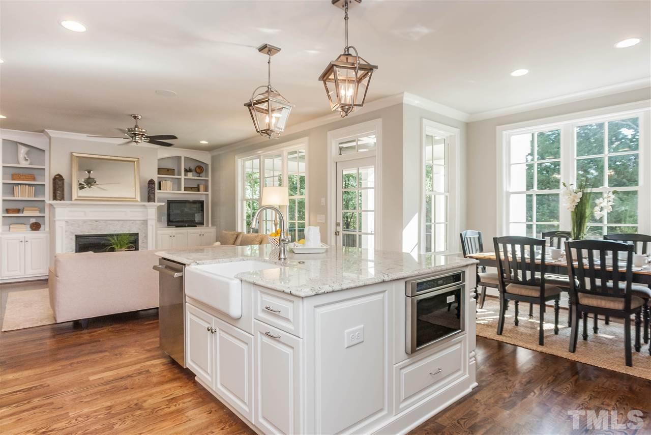 3106 Ashel Street Raleigh, NC 27612 - Photo 11 of 25 a kitchen with stainless steel appliances granite countertop a stove and a wooden floors