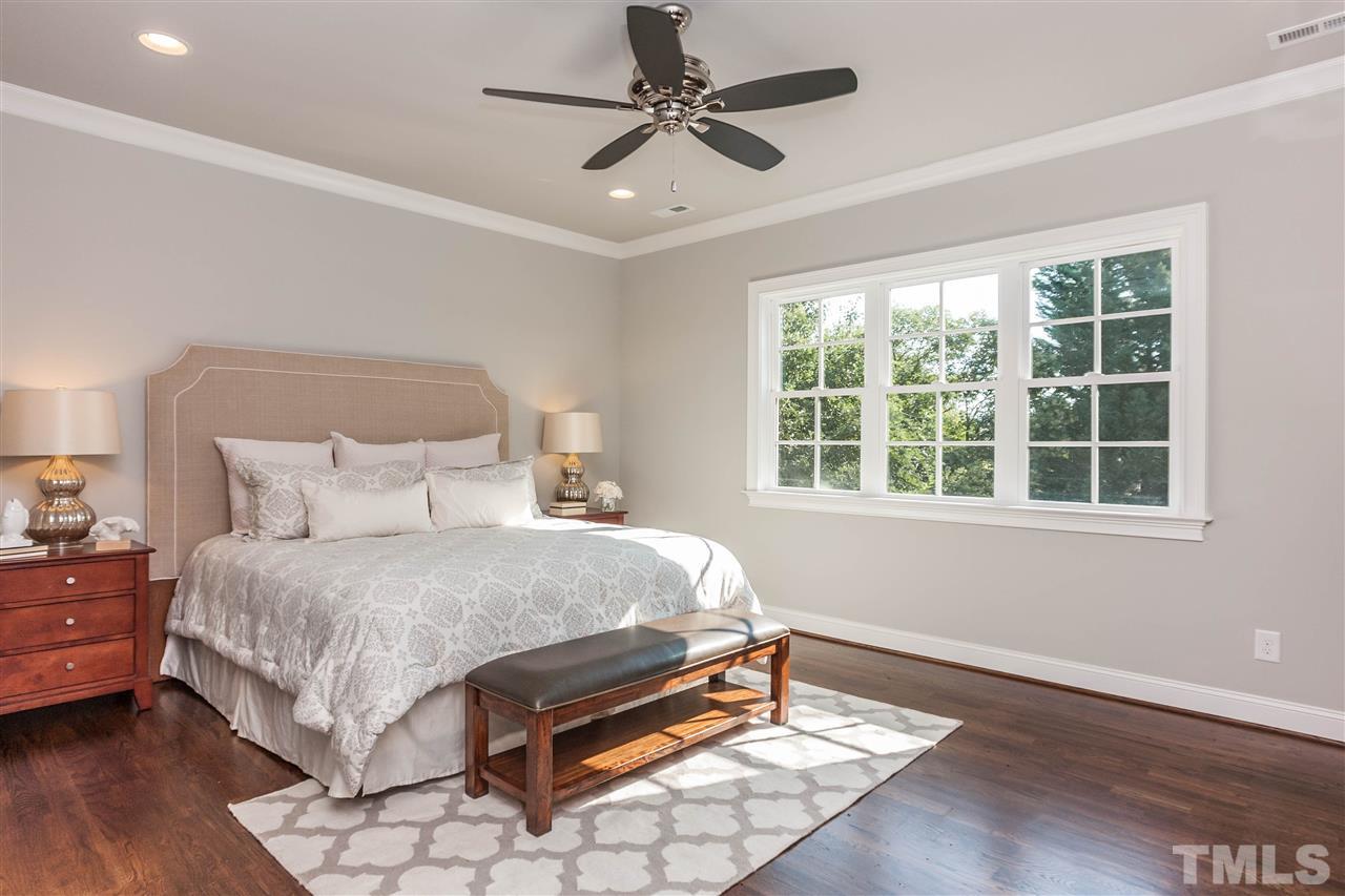 3106 Ashel Street Raleigh, NC 27612 - Photo 16 of 25 a bedroom with a bed chandelier and a window