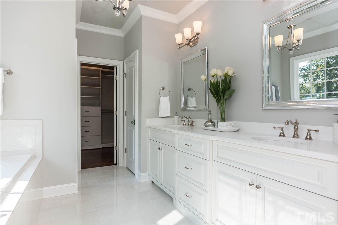 3106 Ashel Street Raleigh, NC 27612 - Photo 17 of 25 a bathroom with a granite countertop sink a mirror and a shower