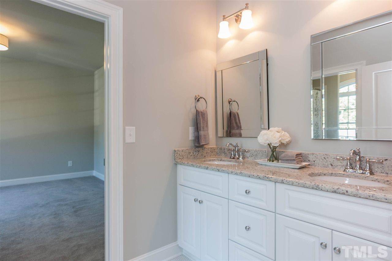 3106 Ashel Street Raleigh, NC 27612 - Photo 21 of 25 a bathroom with a granite countertop sink and a mirror