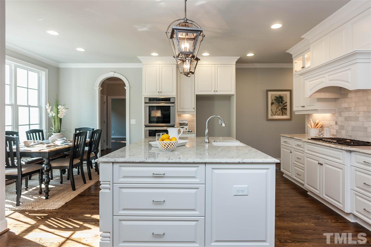 3106 Ashel Street Raleigh, NC 27612 - Photo 8 of 25 a kitchen with stainless steel appliances granite countertop a stove and a sink