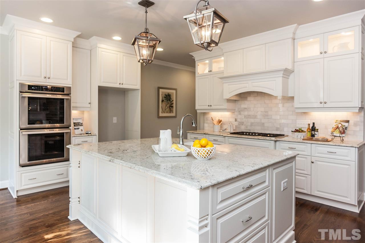 3106 Ashel Street Raleigh, NC 27612 - Photo 9 of 25 a kitchen with a sink stainless steel appliances and chandelier