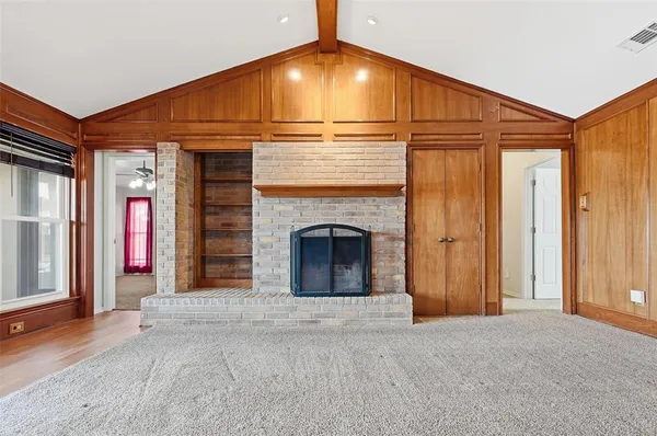a view of an empty room with a ceiling fan