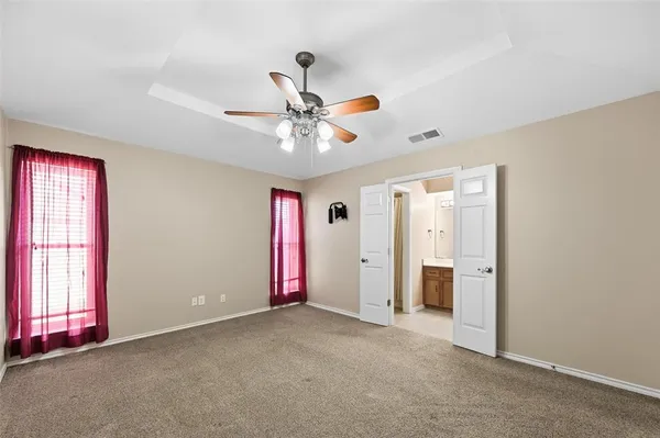 a bathroom with a sink a toilet and shower curtain
