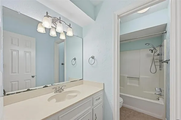 a bathroom with a granite countertop shower and a sink