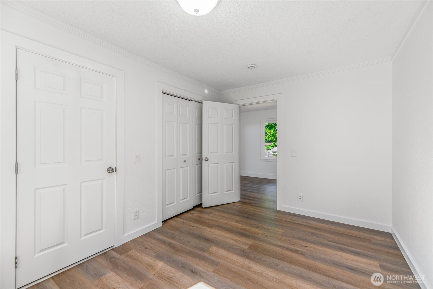 7051 South 125th Street Seattle, WA 98178 - Photo 14 of 32 a view of an empty room with window and wooden floor