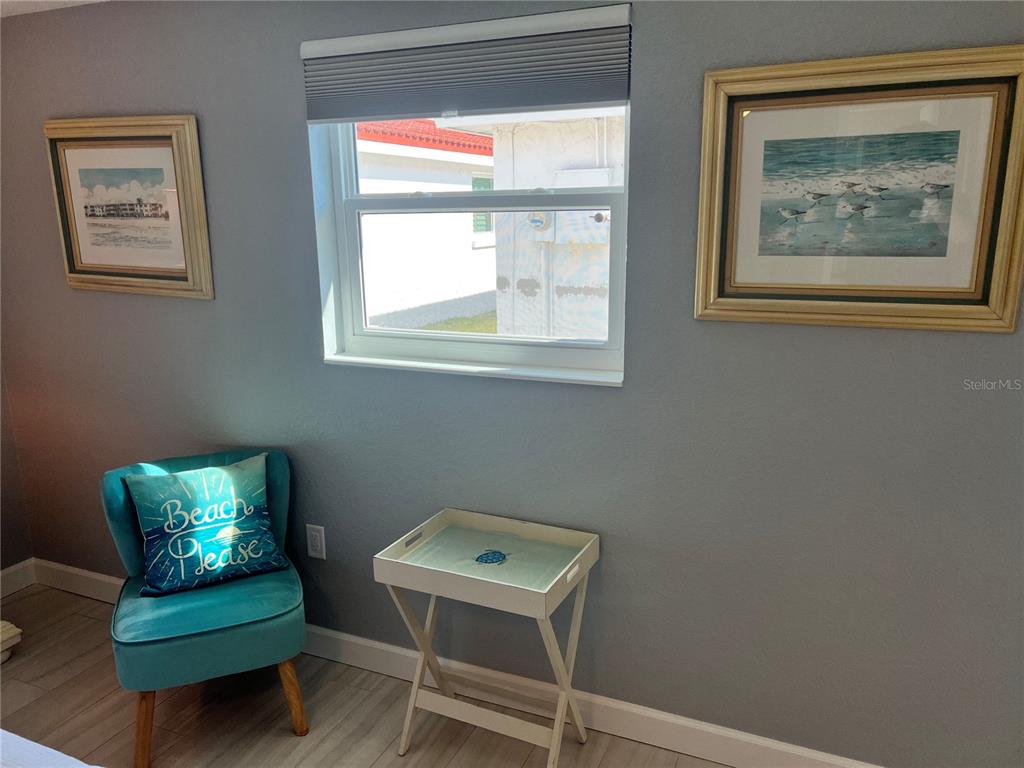 6154 Midnight Pass Road, Unit B02 Sarasota, FL 34242 - Photo 12 of 14 a view of a room with lounge chair and a window
