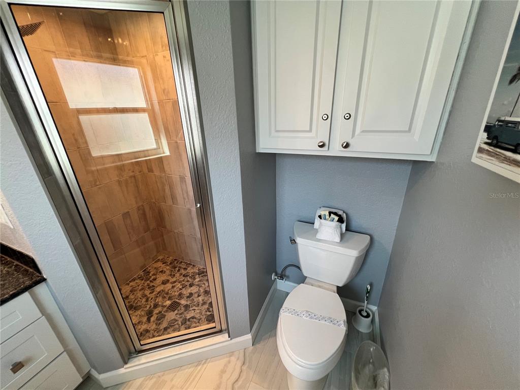 6154 Midnight Pass Road, Unit B02 Sarasota, FL 34242 - Photo 14 of 14 a bathroom with a toilet sink and a mirror