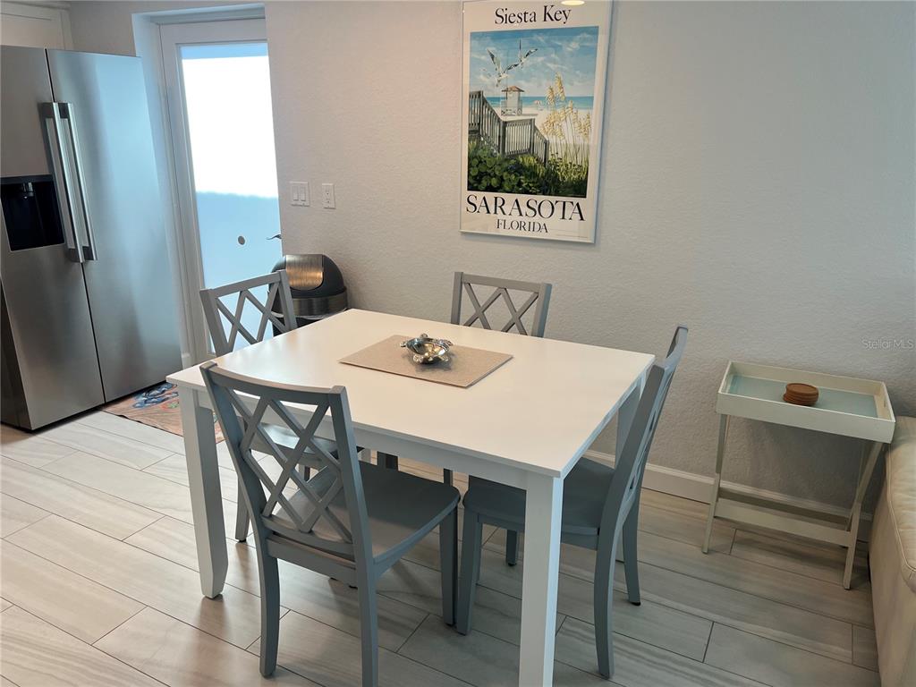 6154 Midnight Pass Road, Unit B02 Sarasota, FL 34242 - Photo 2 of 14 a view of a dining room with furniture and a window