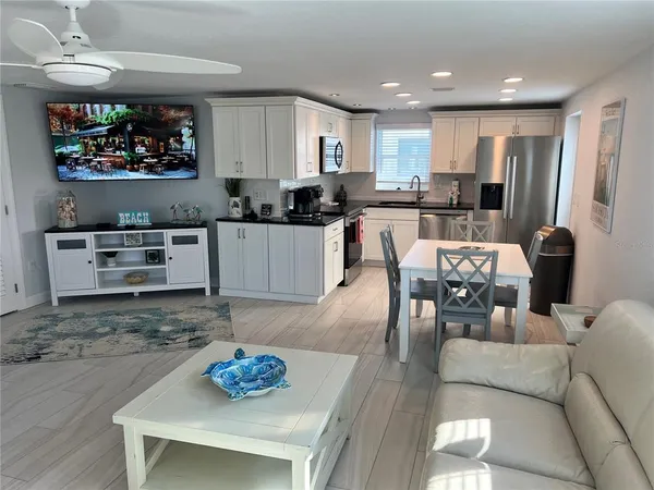 a kitchen with stainless steel appliances granite countertop a refrigerator and a stove top oven