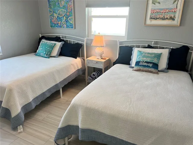 a bedroom with bed and wall painting with wooden floor